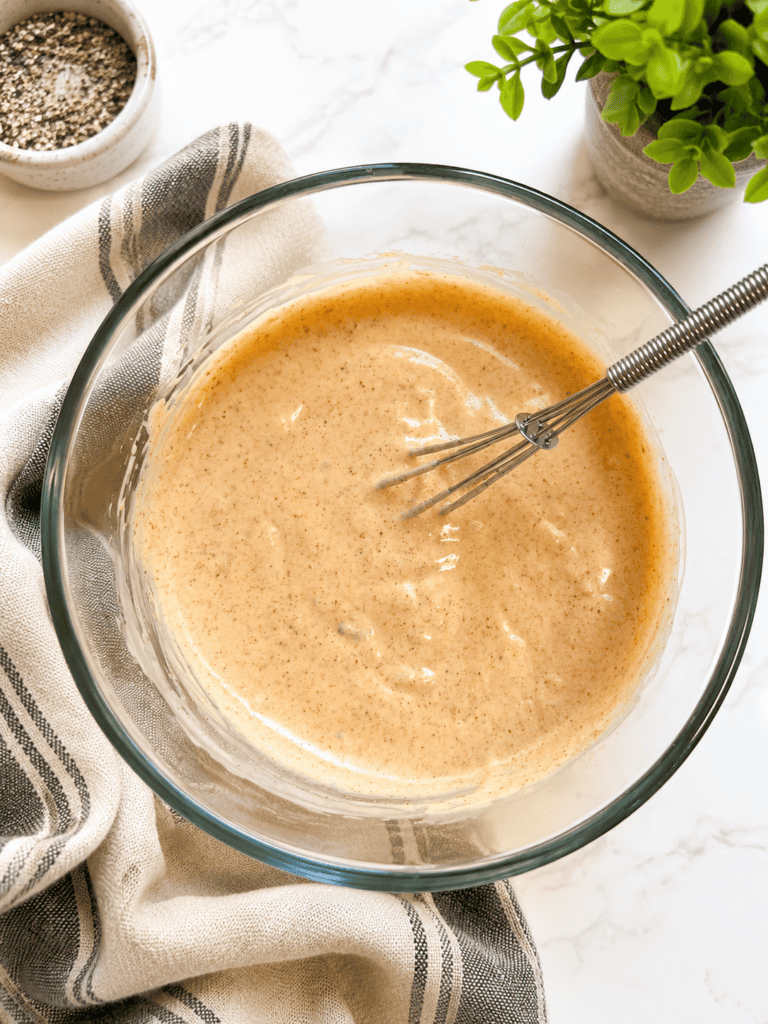 Creamy homemade burger sauce whisked in a glass bowl with paprika, mayonnaise, ketchup, mustard, and pickle relish, ready to drizzle over loaded burger bowls.