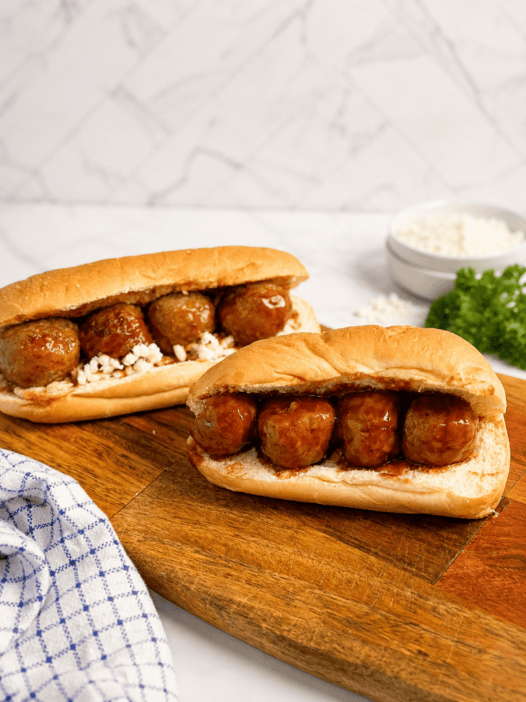 Easy meatball subs made with grape jelly meatballs, fresh shredded mozzarella cheese, and toasted hoagie rolls. A delicious family dinner made from slow cooker BBQ grape jelly meatballs.
