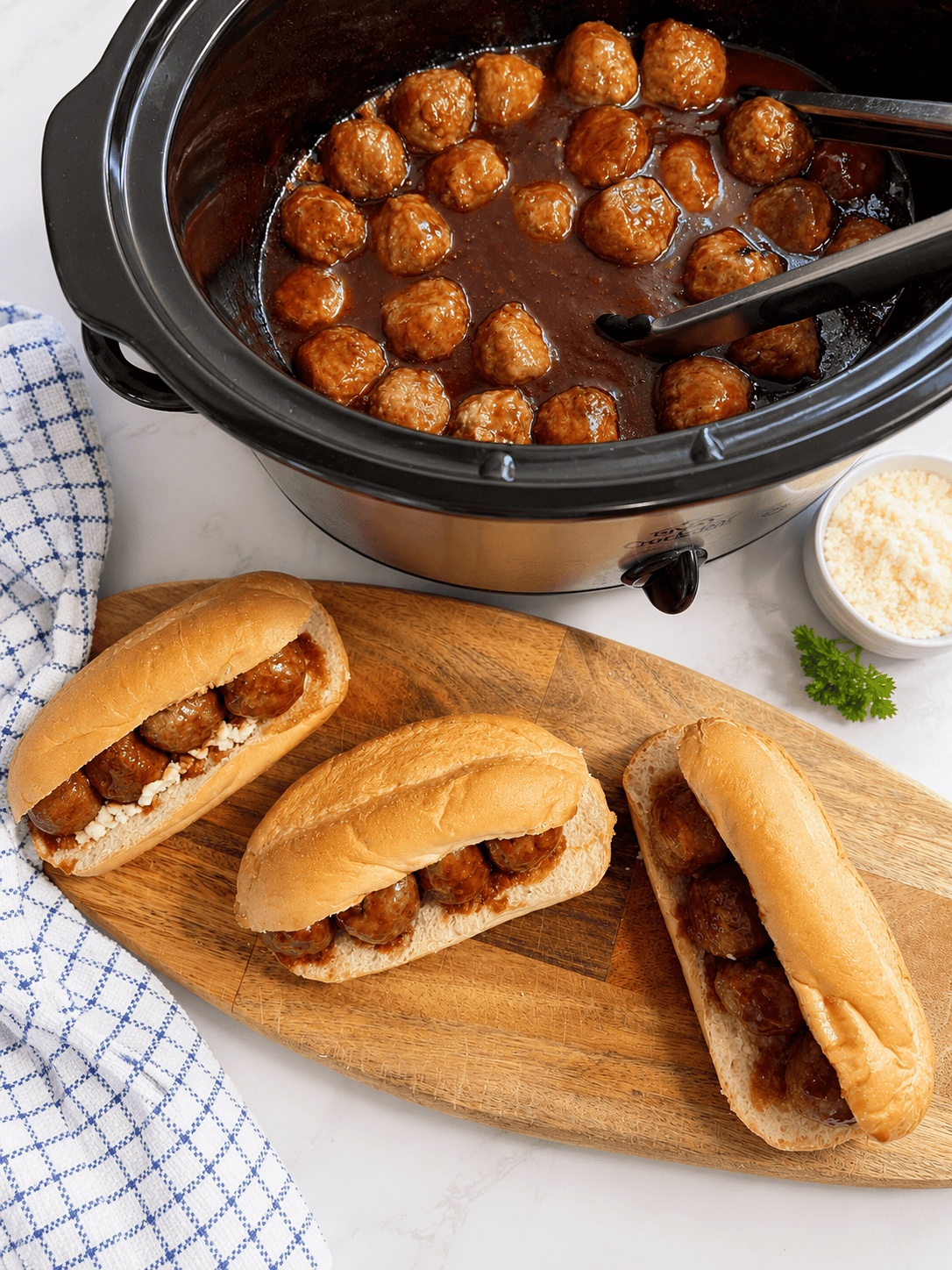 Grape jelly meatballs cooking in a slow cooker with a sweet and tangy BBQ sauce. This easy crockpot grape jelly meatballs recipe is made with frozen meatballs and simple ingredients for the perfect party appetizer.