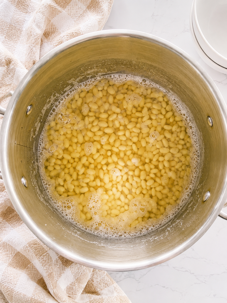 Quick-soaked navy beans after resting in hot water, ready to use for homemade baked beans with ground beef and bacon.