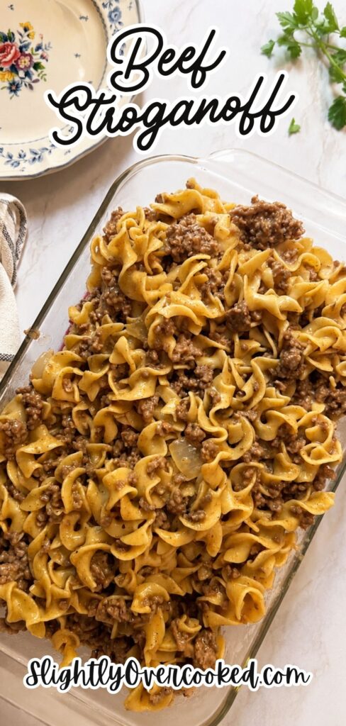 Easy Classic Beef Stroganoff Recipe made with ground beef, egg noodles, mushrooms, beef broth, and a creamy sour cream sauce in a glass baking dish. This homemade beef stroganoff is a quick and comforting family dinner that's perfect for busy weeknights, featuring rich savory flavor and simple pantry ingredients.