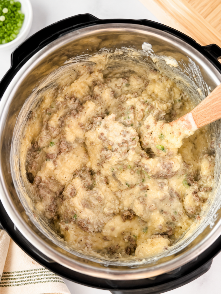 potato casserole in the instant pot with all of the ingredients mixed in. 