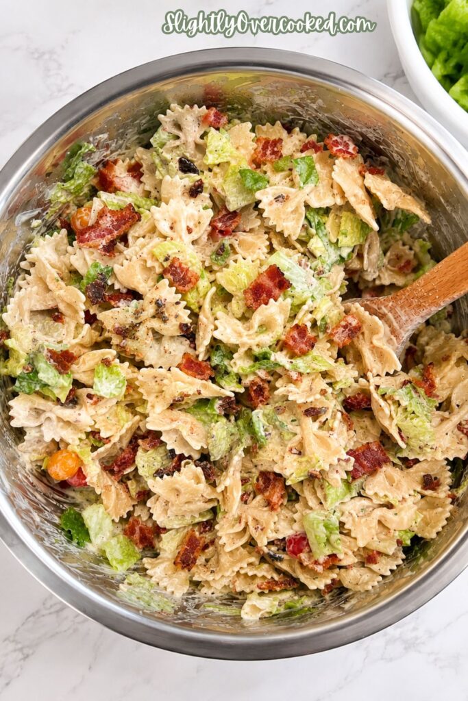 Easy BLT pasta salad recipe served cold with crispy bacon, bow tie pasta, romaine lettuce, and cherry tomatoes.