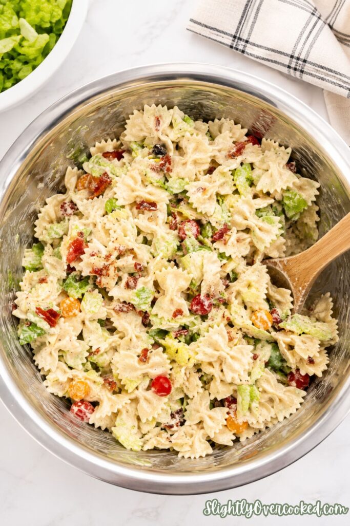 Homemade bacon ranch pasta salad made with bow tie pasta, fresh lettuce, and juicy tomatoes.