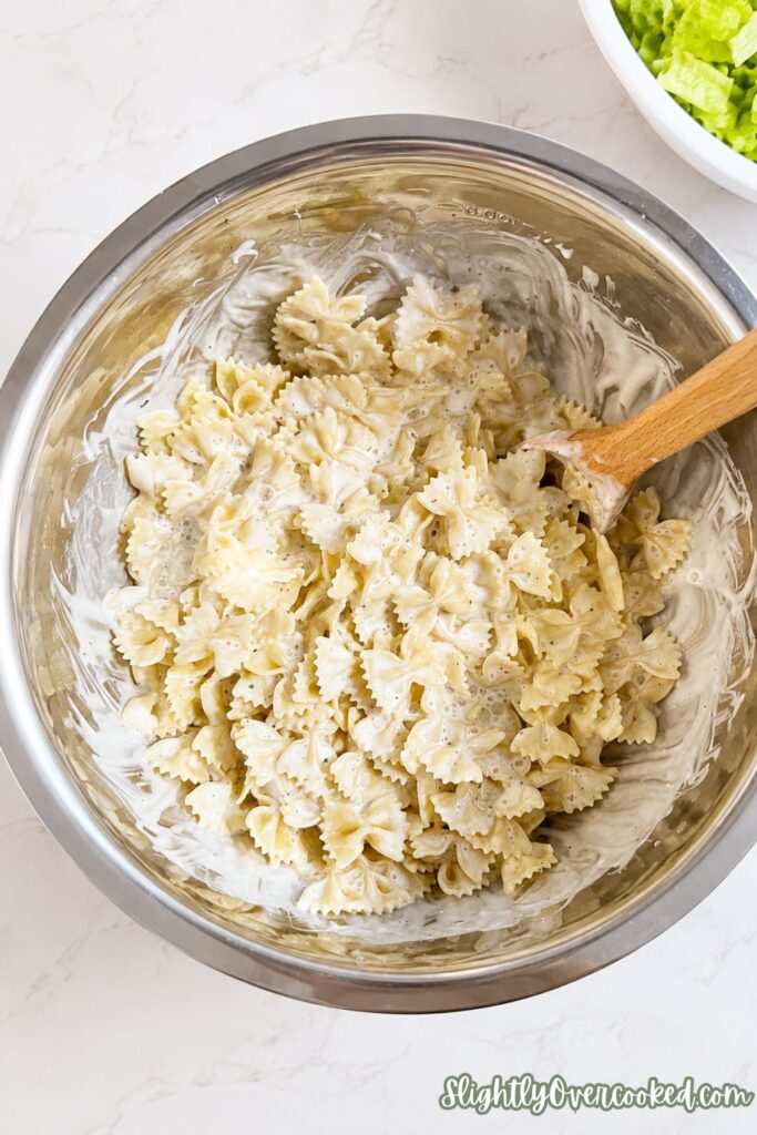 Warm bow tie pasta coated in creamy ranch dressing before adding the fresh ingredients.