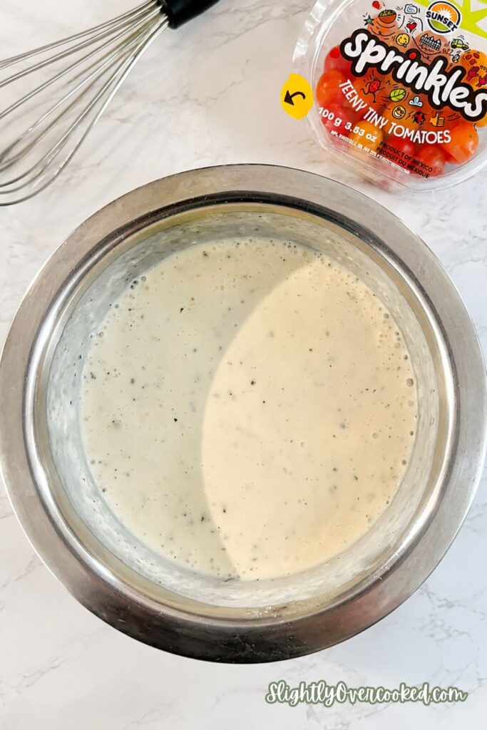 Homemade ranch dressing mixed until smooth for a creamy bacon and pasta salad recipe.