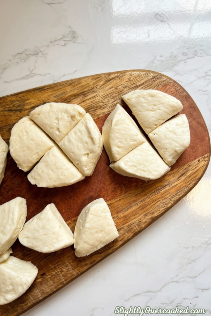 Homemade biscuit dumpling pieces ready to add to creamy chicken and vegetable mixture