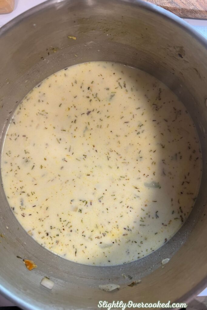 Creamy seasoned broth mixture prepared for chicken and dumplings before adding shredded chicken