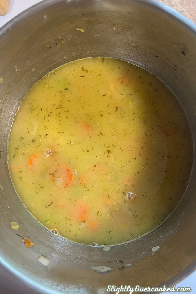 vegetables simmering in seasoned chicken broth for a creamy dumpling recipe