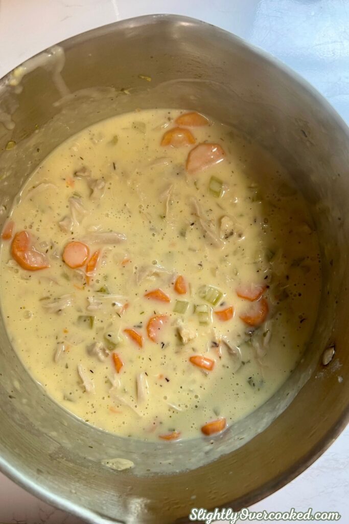 Creamy chicken and vegetable mixture with shredded chicken, carrots, celery, and herbs