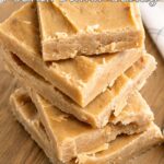 Close-up of stacked old fashioned peanut butter candy squares with a creamy fudge-like texture on a wooden board