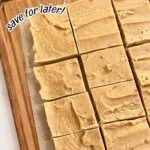 Old fashioned peanut butter candy cut into squares and displayed on parchment paper over a wooden cutting board