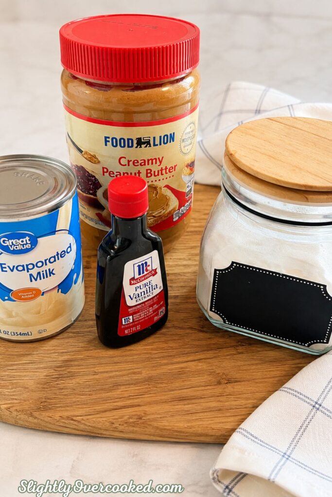 Peanut butter, evaporated milk, sugar and vanilla arranged for an easy homemade candy recipe