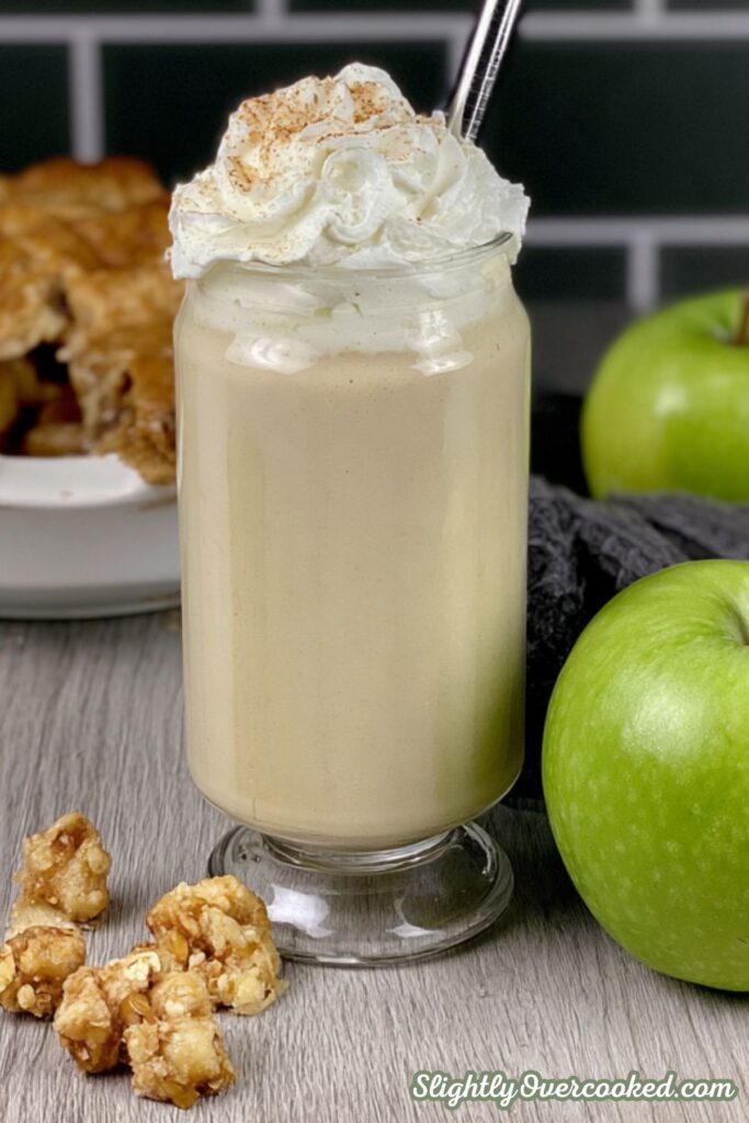 Another time I make this fall milkshake, I topped it with whipped cream and cinnamon. This image shows that with an apple pie behing the shake.