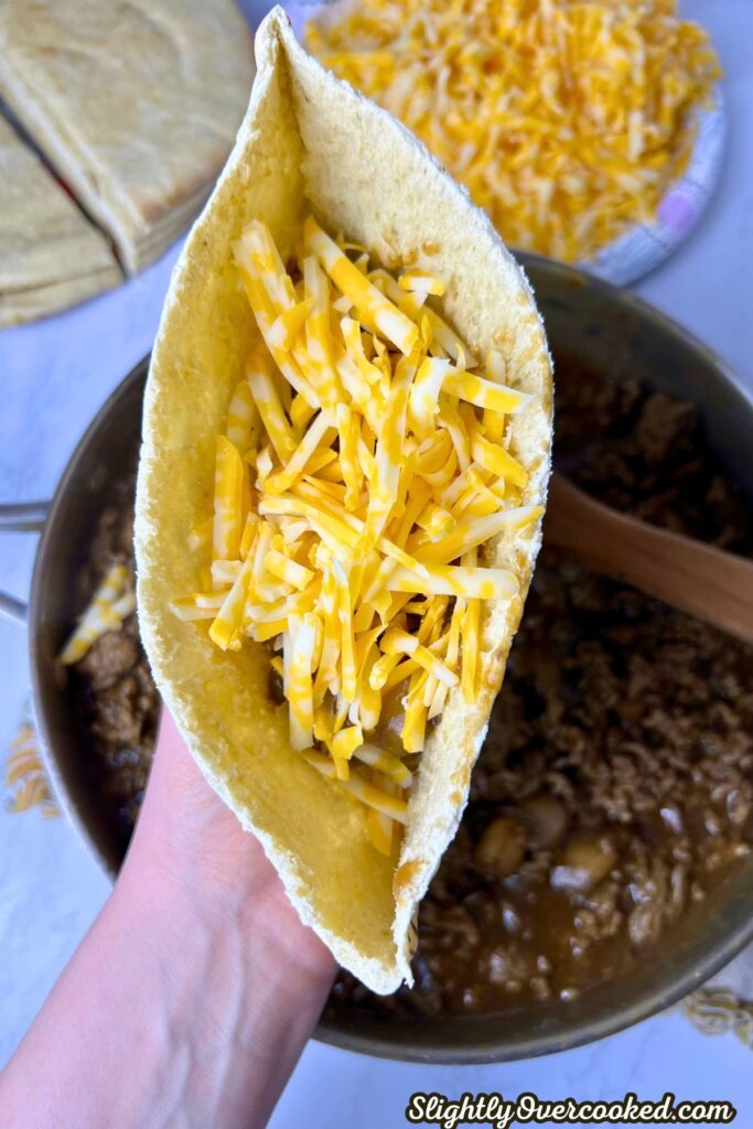 pita bread pocket with cheese, ground beef gravy and cheese.