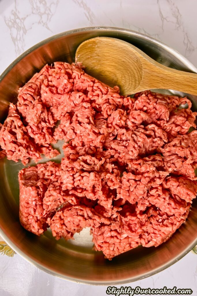 raw uncooked ground beef in a skillet