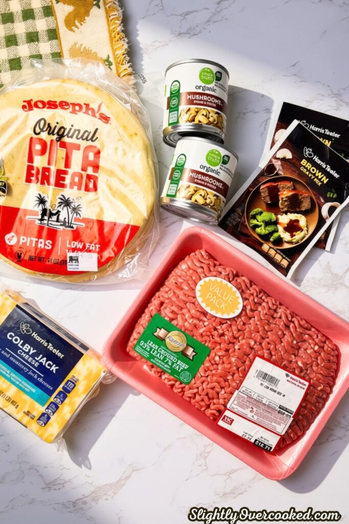 ground beef package, cheese, pita bread, beef gravy layed out for the ingredients